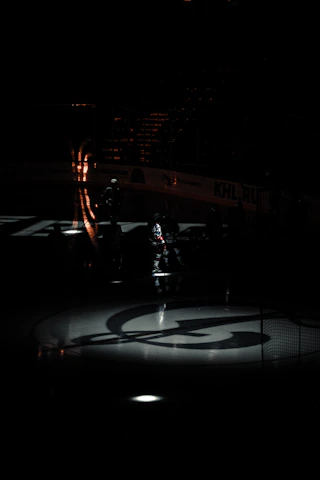 Close-up of a player preparing to take a penalty shot under golden stadium lights.