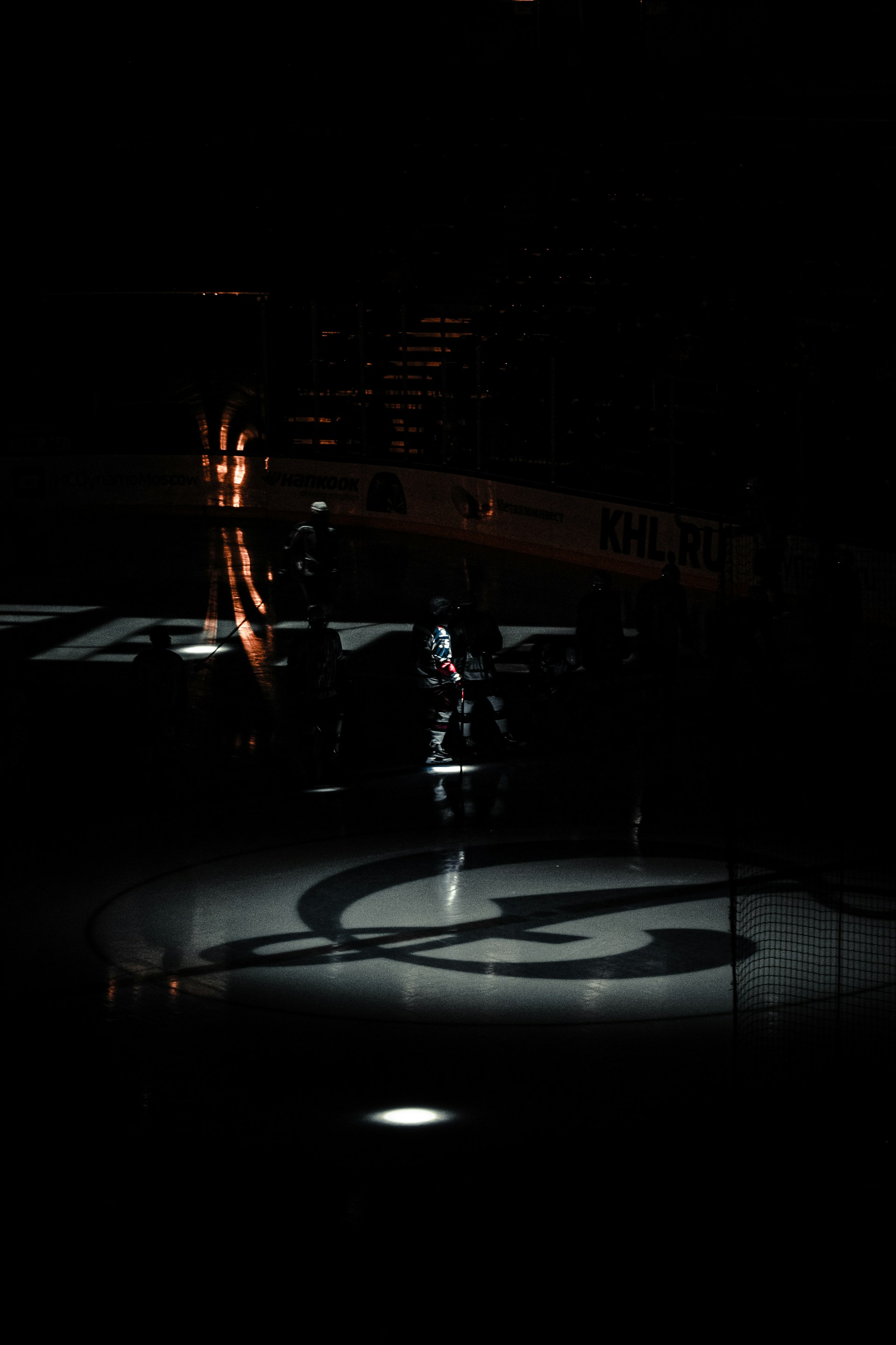 The outdoor arena at dusk, softly lit with the silhouette of the old Inkerman Rockets banner hanging proudly in the background.
