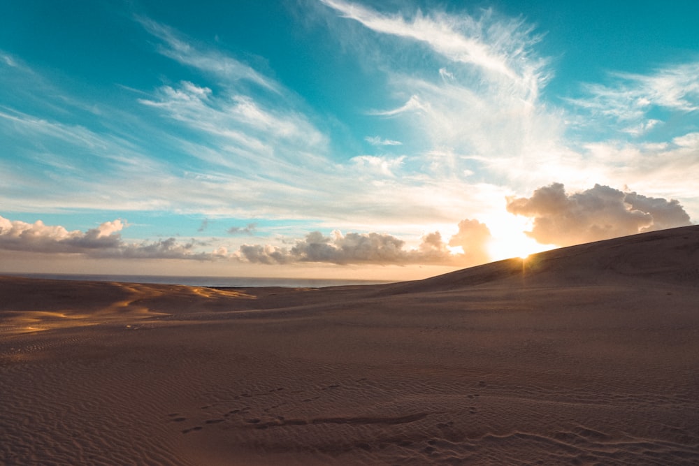 brown sand under blue sky during daytime