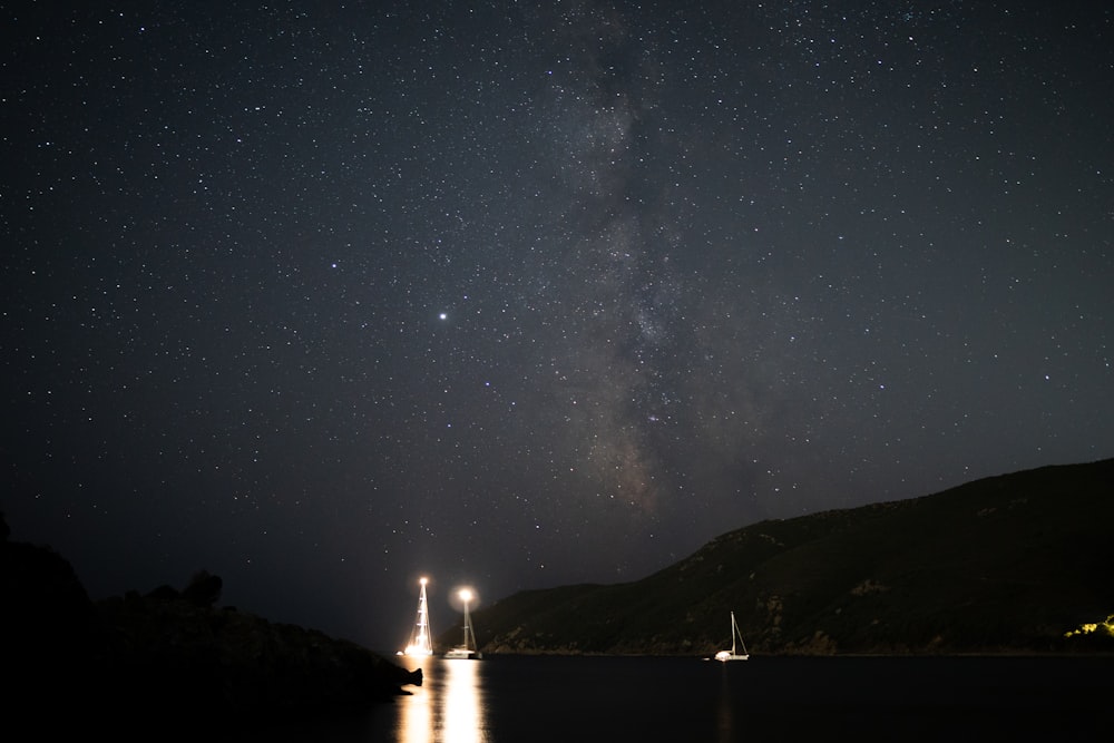 lighted candle on the lake during night time