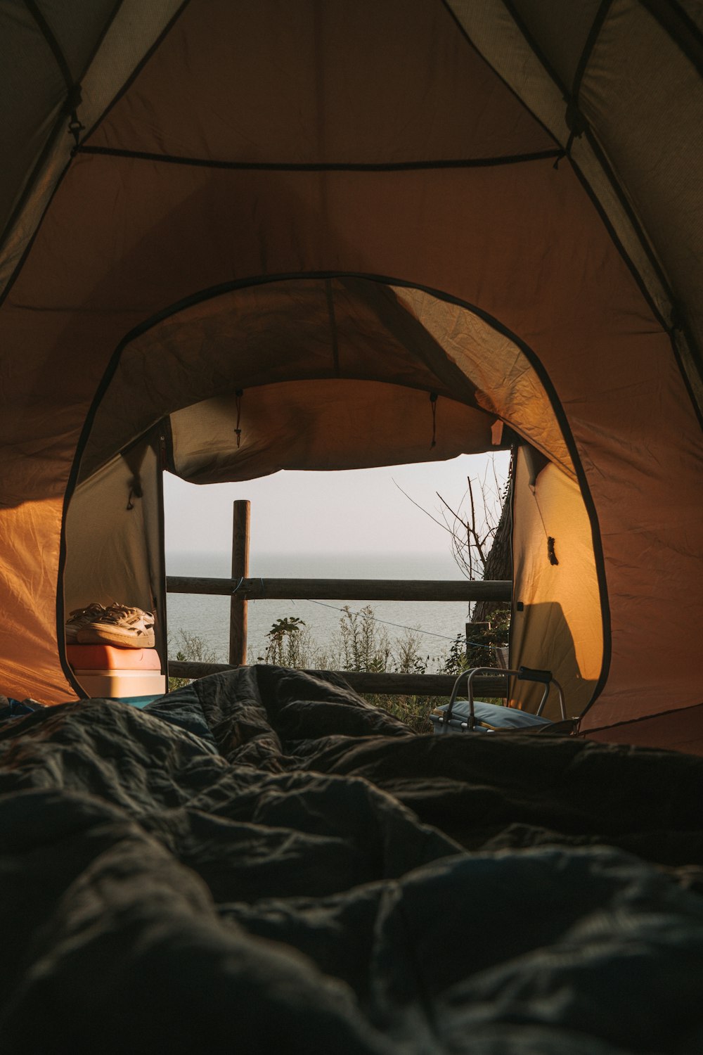 yellow and white tent near body of water during daytime