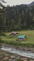 green and brown house on green grass field
