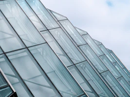 Close-up of sleek tempered glass panels stacked in a modern warehouse.