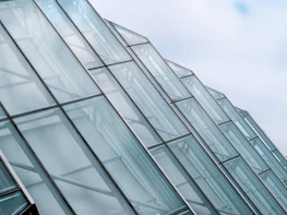 Tempered glass panel installed in modern architecture highlighting stress distribution.
