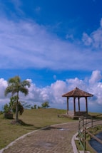 A welcoming outdoor pavilion with soft greenery and a clear blue sky, inviting visitors to connect.