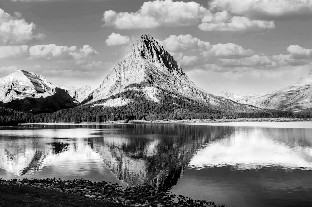 grayscale photo of lake near mountain