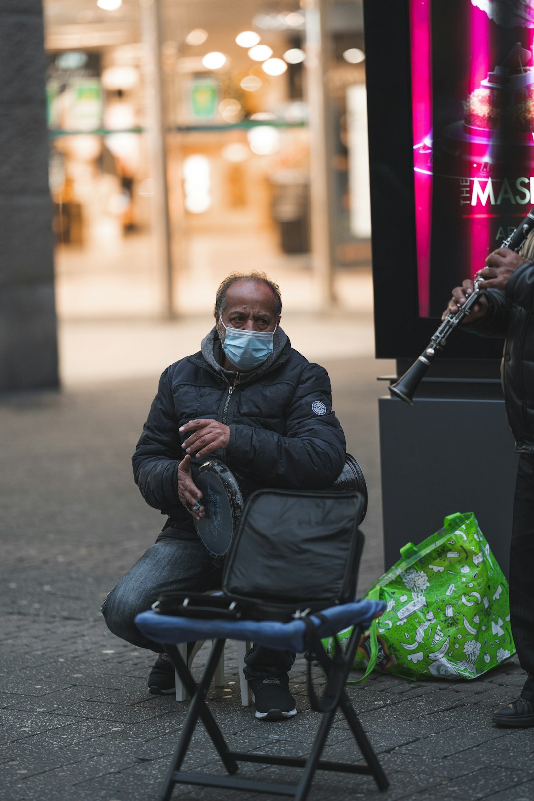 man in black leather jacket playing musical instrument