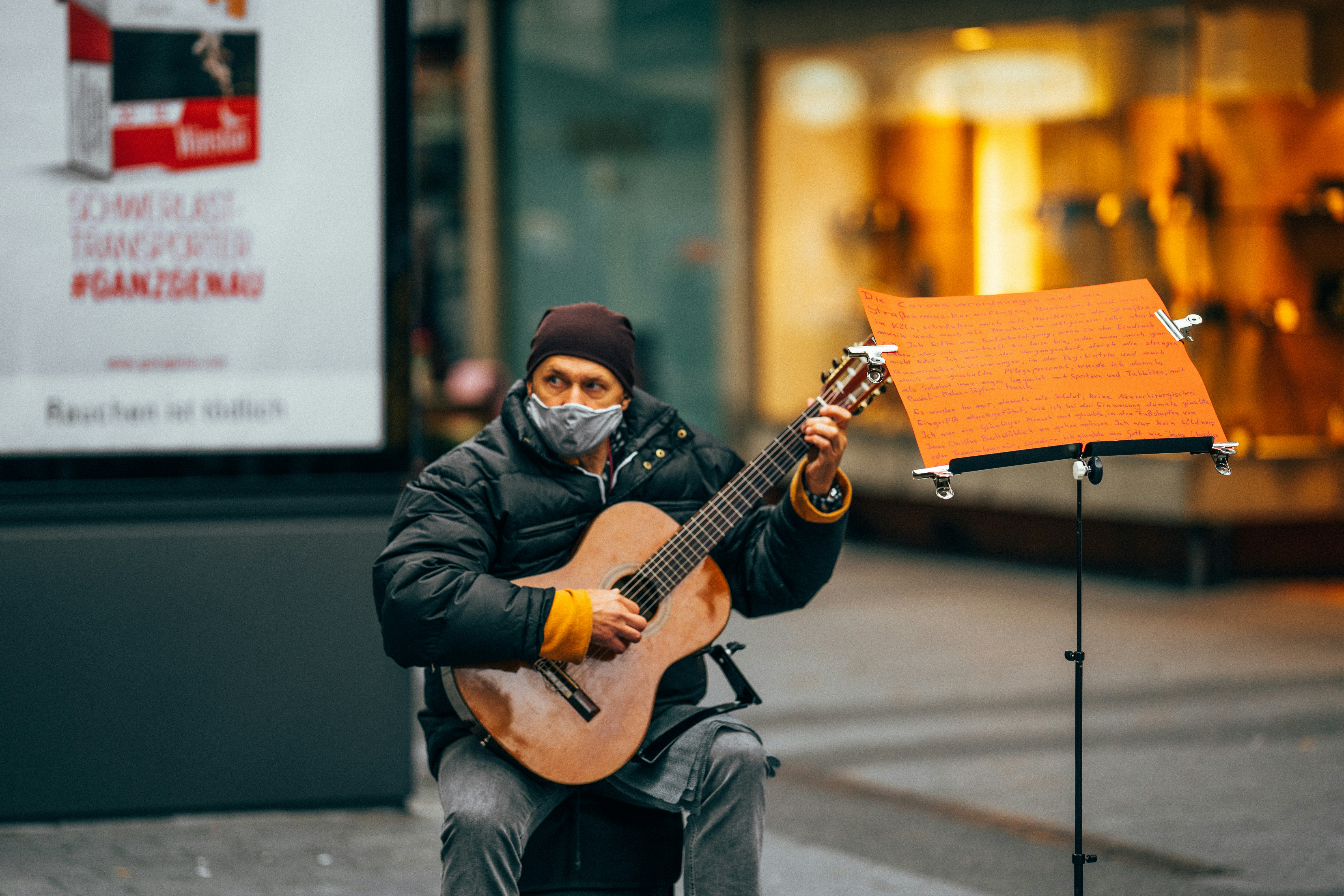 man in black leather jacket playing guitar