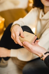 woman in white dress holding a small gift box