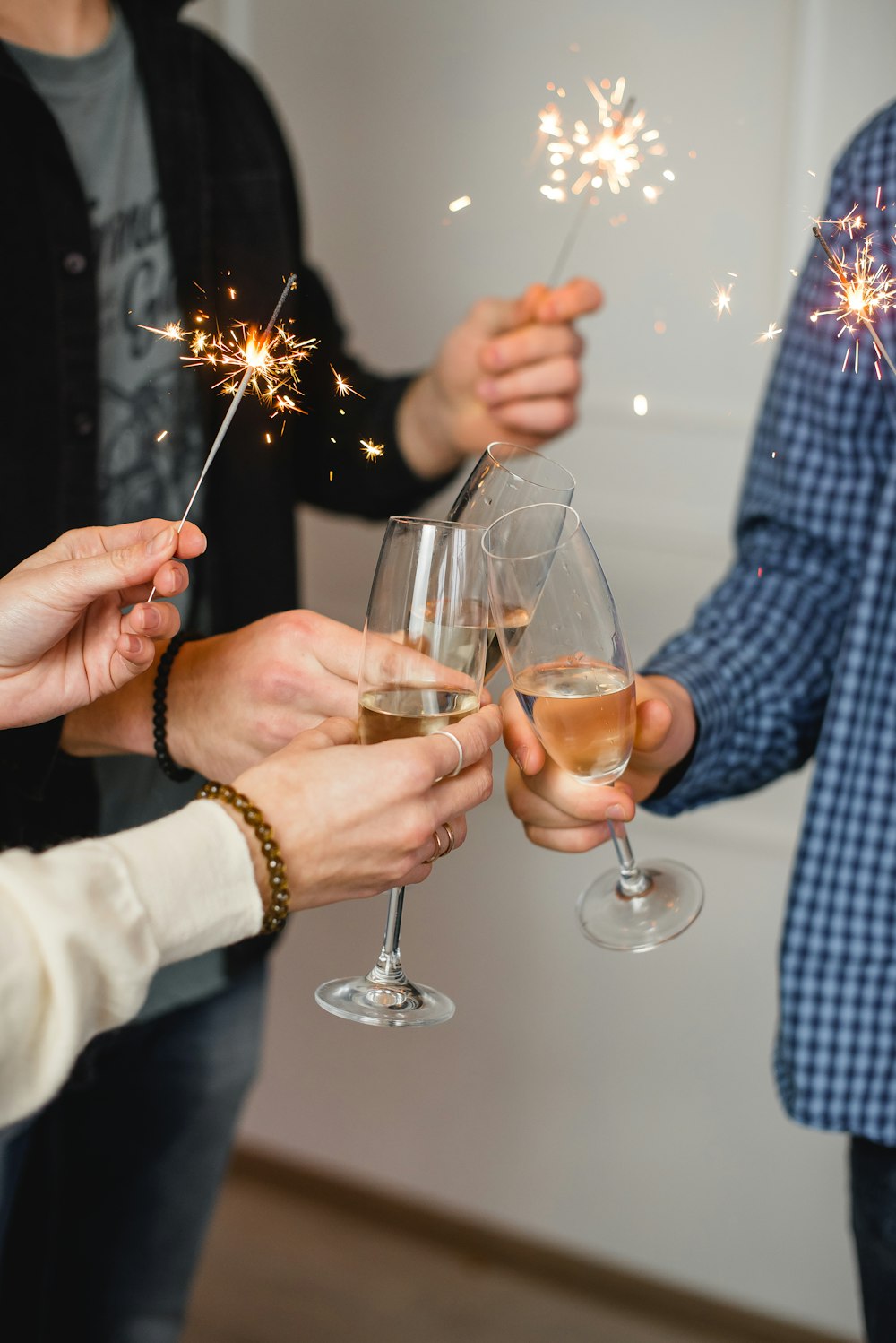 person holding clear wine glass with brown liquid