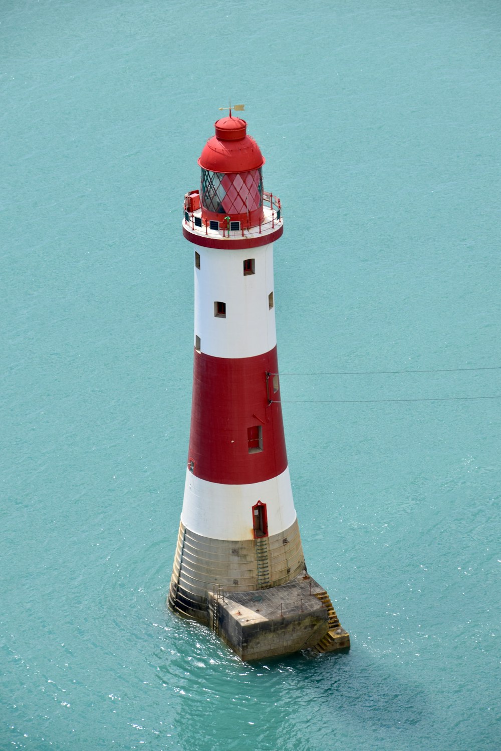 Red and white lighthouse beside photo – Free on Unsplash