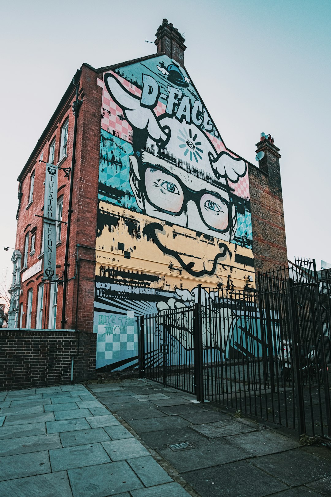 brown brick building with graffiti