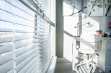 Sunlit study room with custom blinds perfectly matching the minimalist décor.