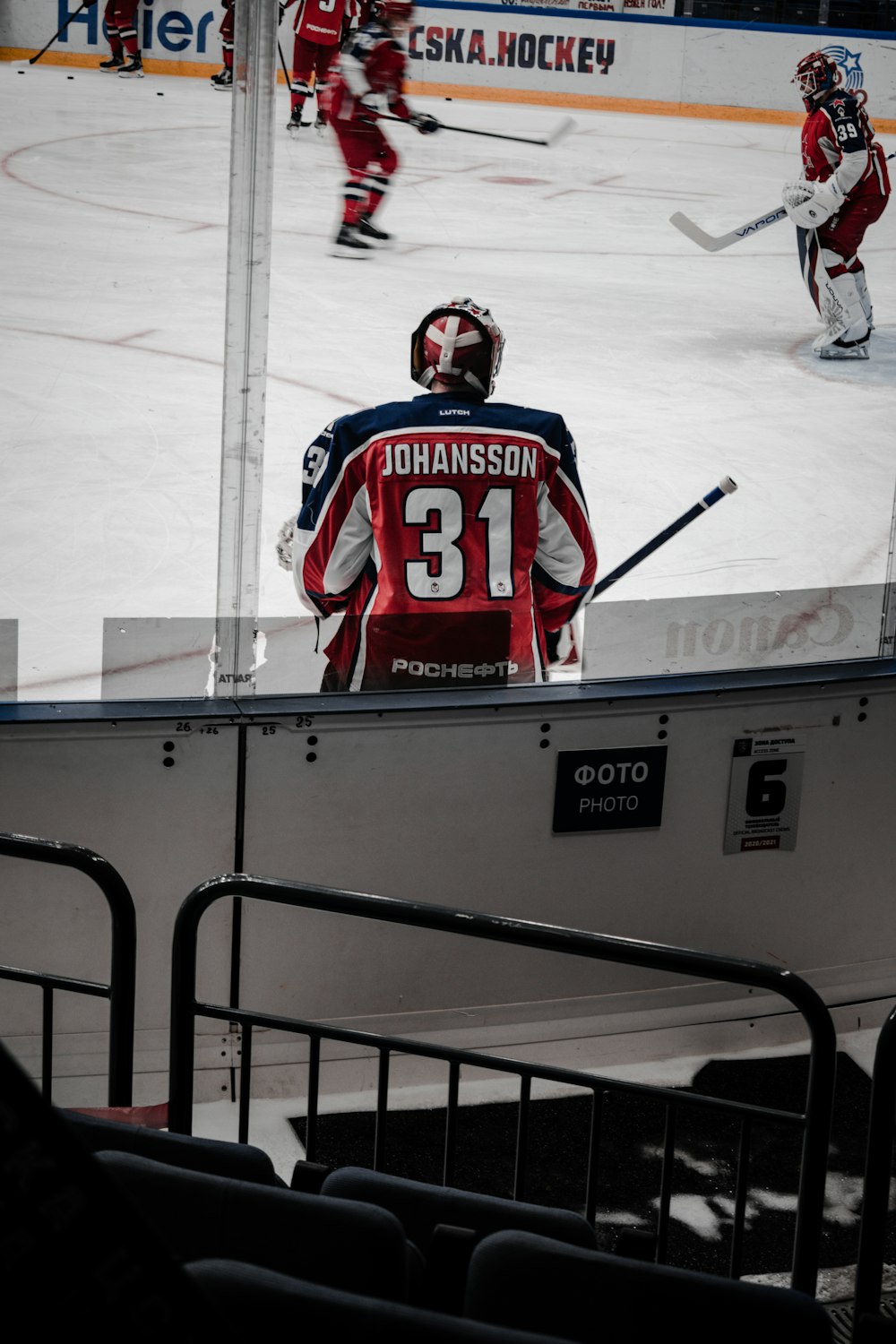 2 men in red and white ice hockey jersey