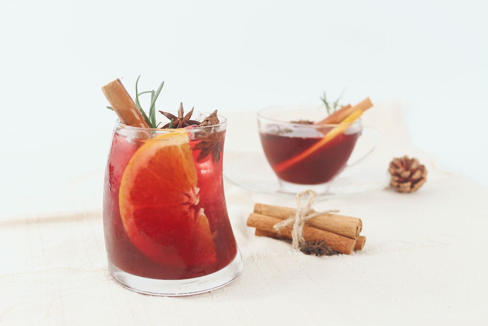 red liquid in clear drinking glass