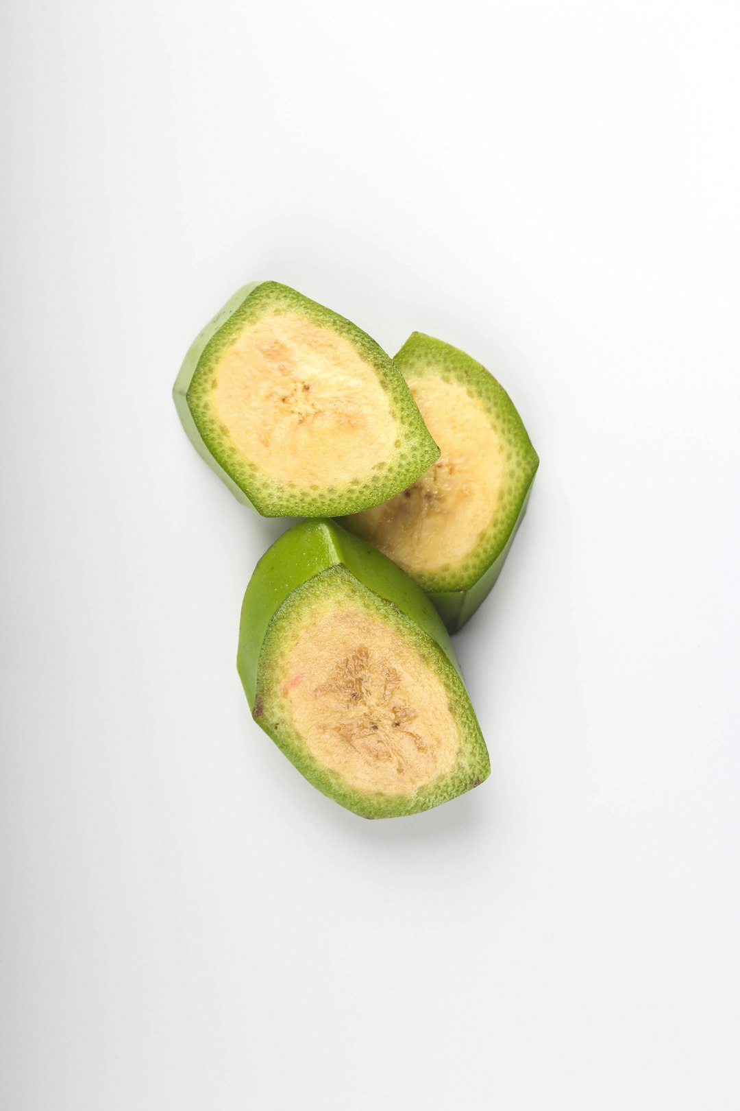 sliced green fruit on white surface