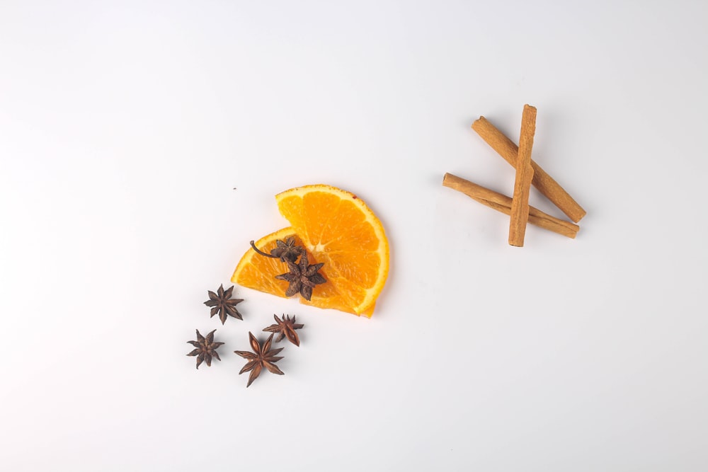 sliced orange fruit beside brown wooden stick
