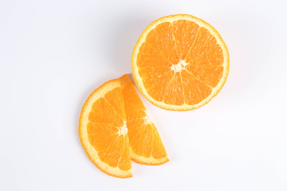 sliced orange fruit on white surface