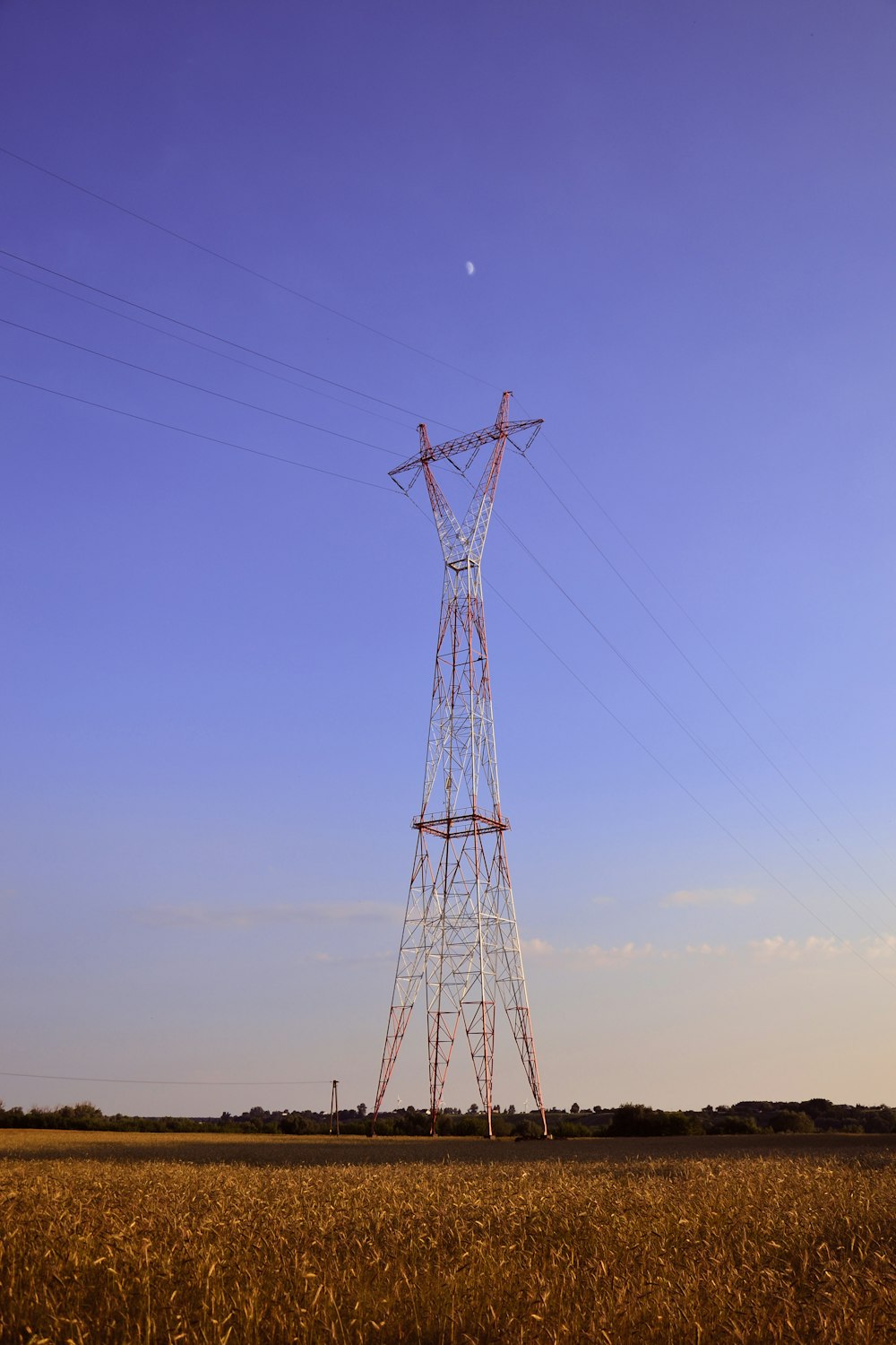 black electric tower under blue sky during daytime