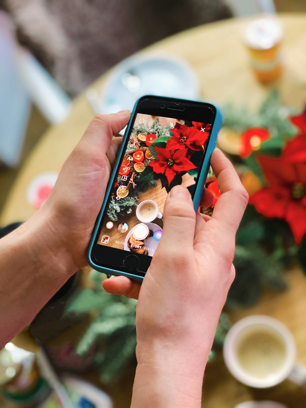 person holding black iphone 5 with red case