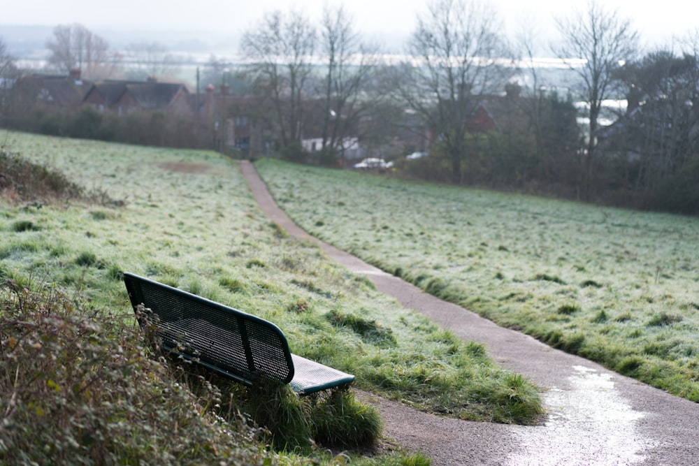 black metal bench on green grass field during daytime