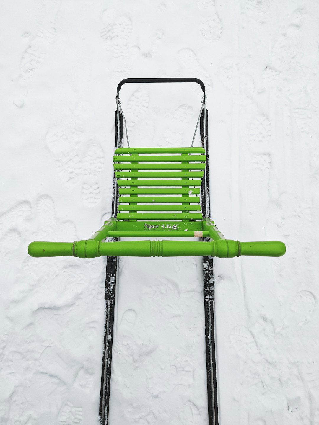 green and black folding chair on white snow