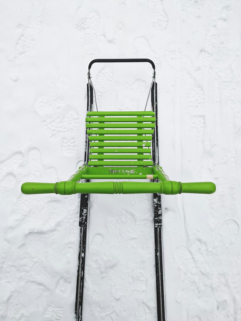 green and black folding chair on white snow