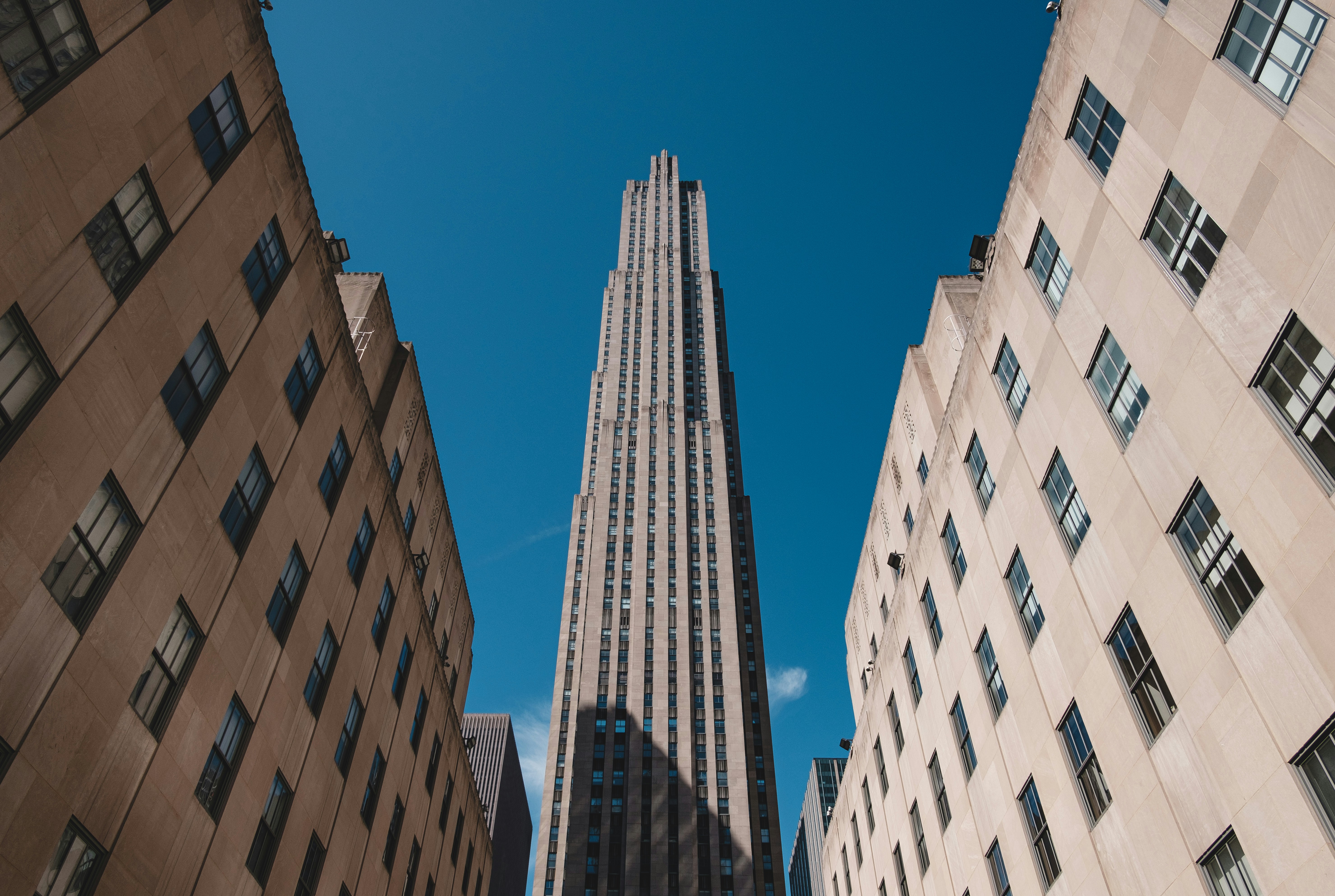 brown and white concrete building under blue sky during daytime