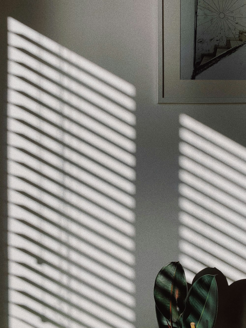 white window blinds near green round ornament