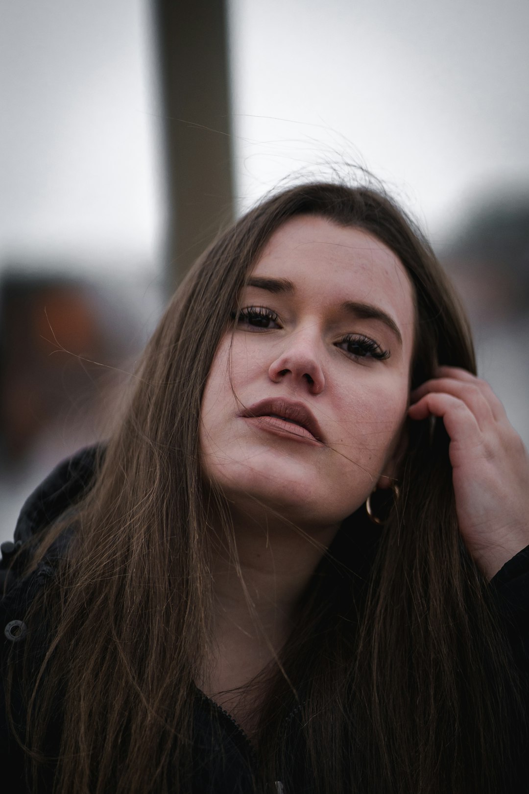 woman in black jacket with brown hair