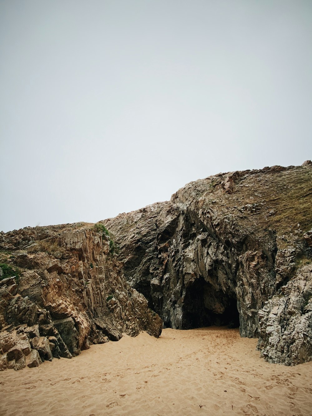 brown rock formation under white sky during daytime