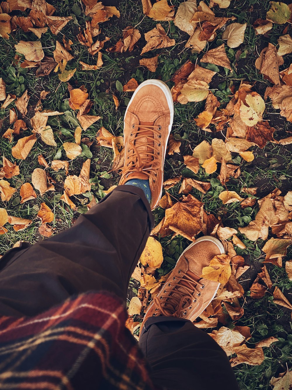 person in brown pants and brown leather shoes