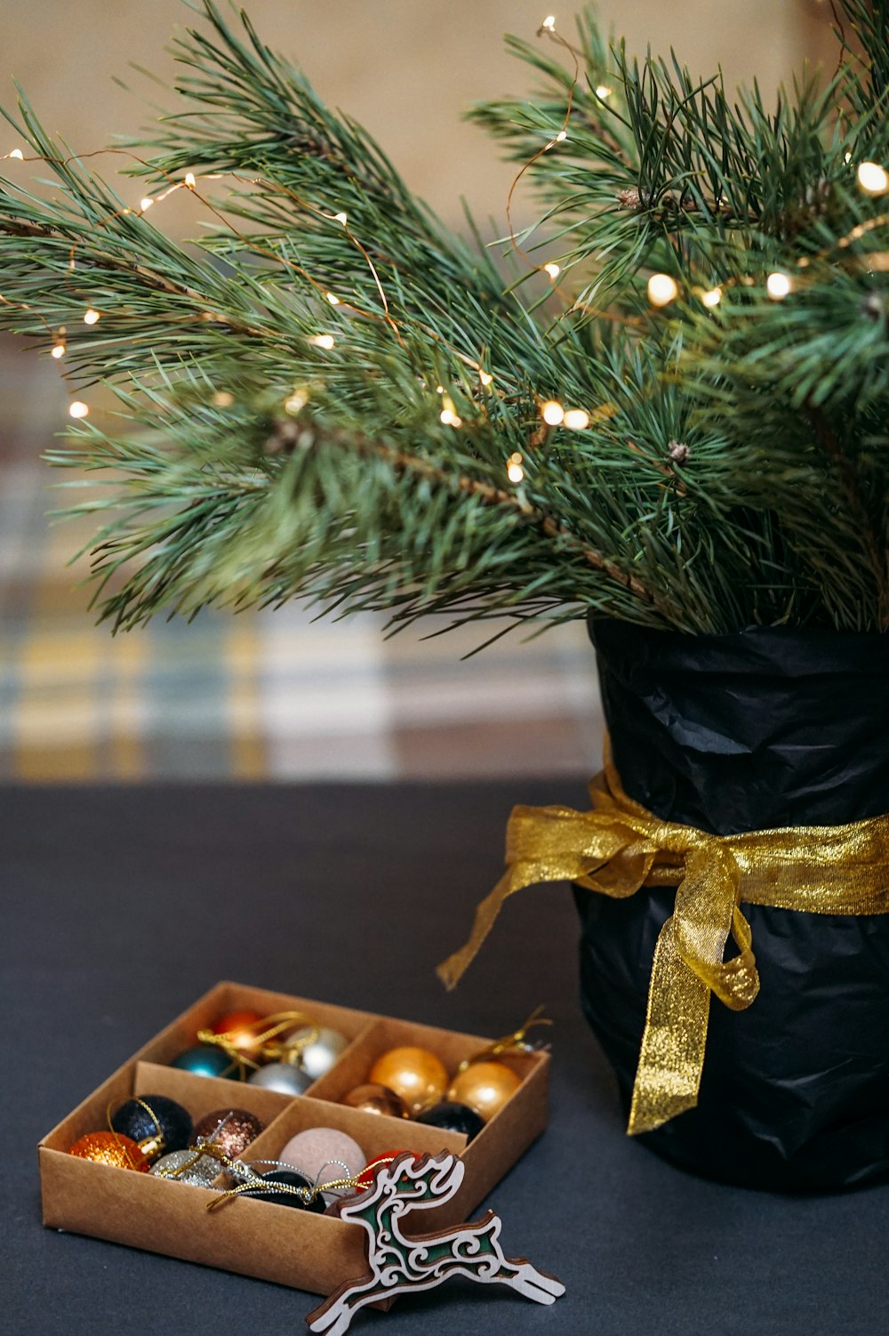 green christmas tree with gold baubles and string lights