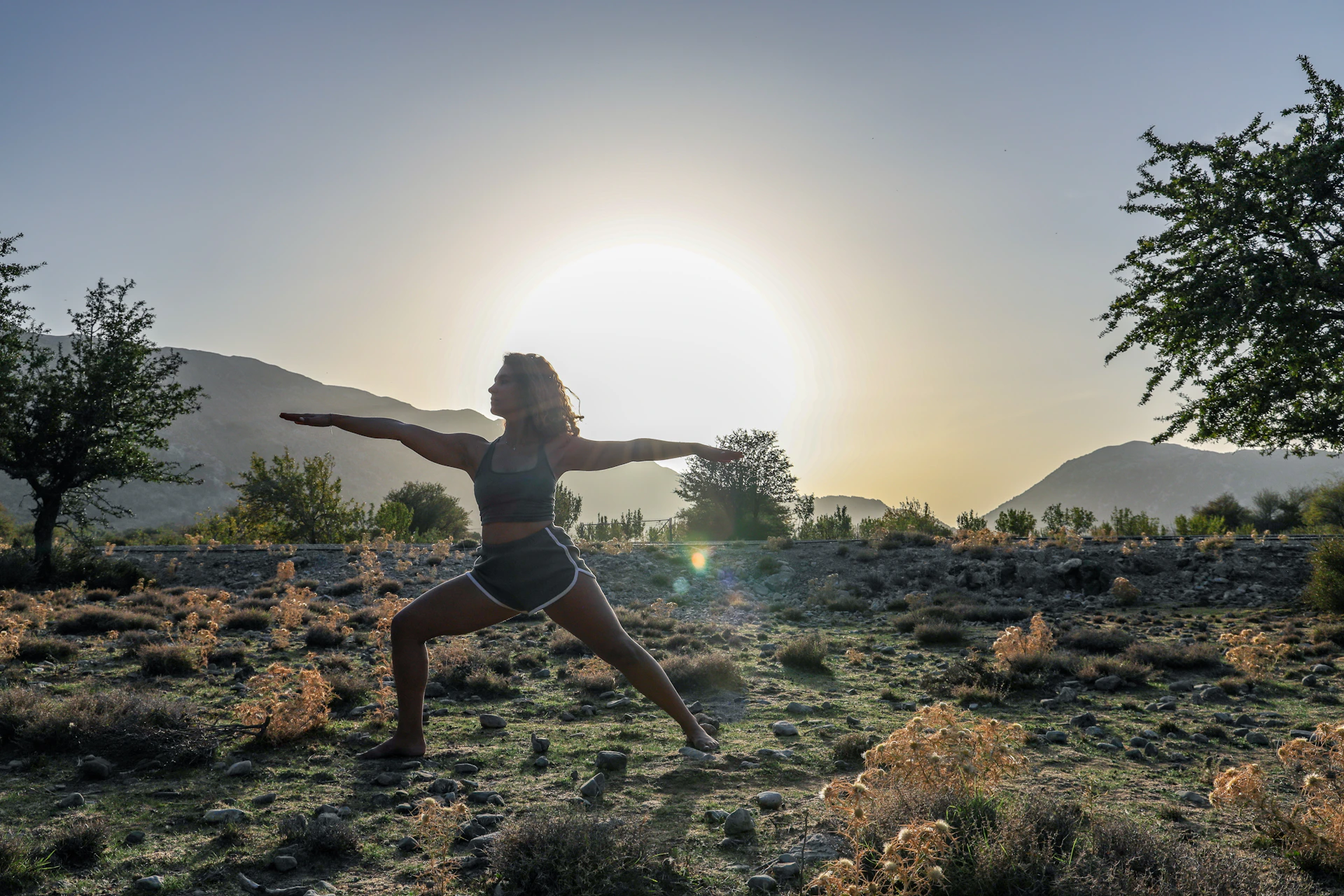 woman in black bikini standing on rocky shore during daytime