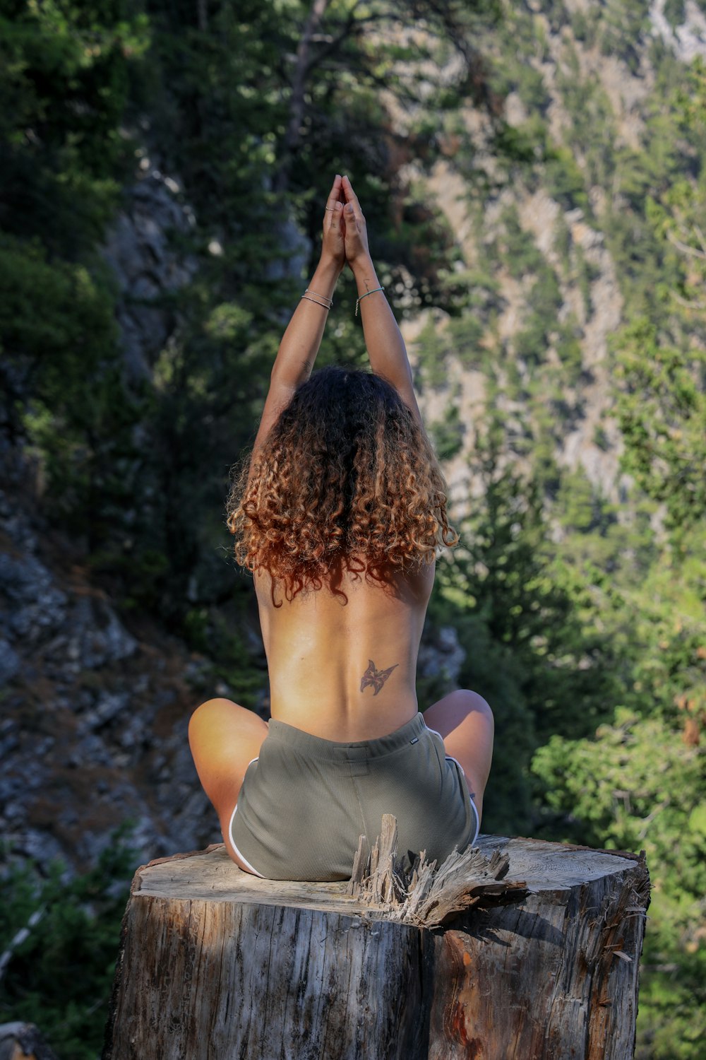 woman in gray tank top raising her both hands