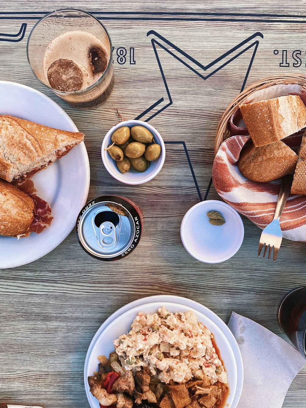 bread on white ceramic plate beside stainless steel fork and bread knife