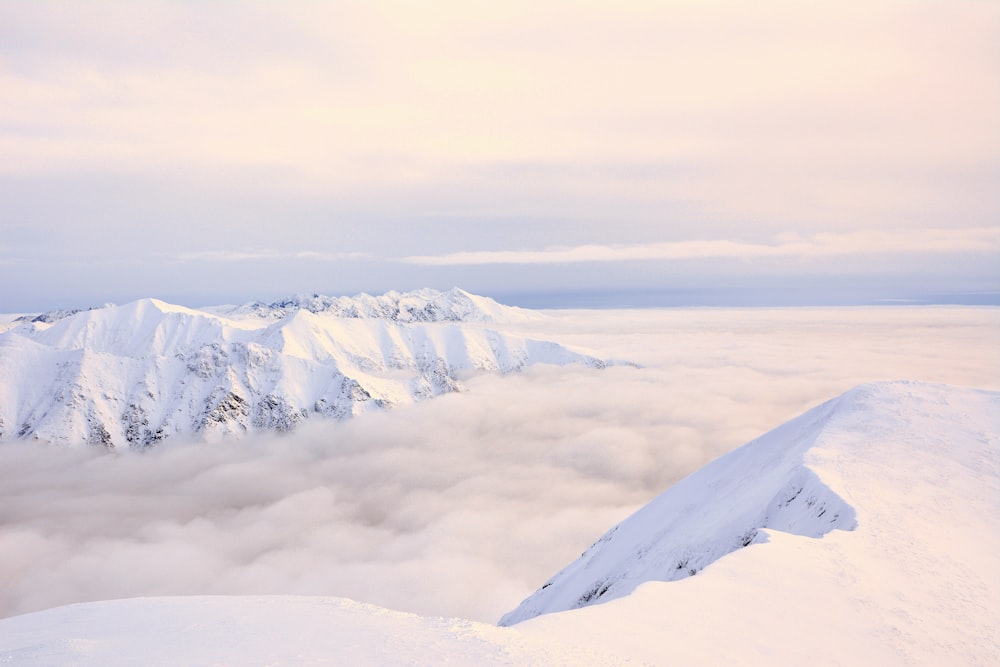 snow covered mountain under cloudy sky during daytime