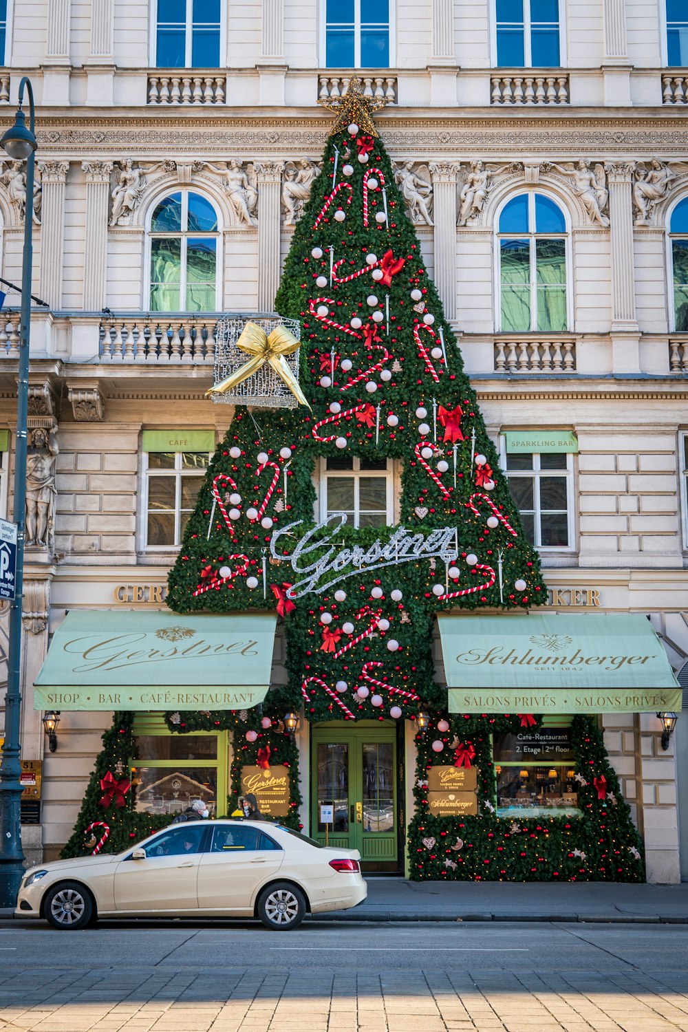 green and red christmas tree with red and white string lights