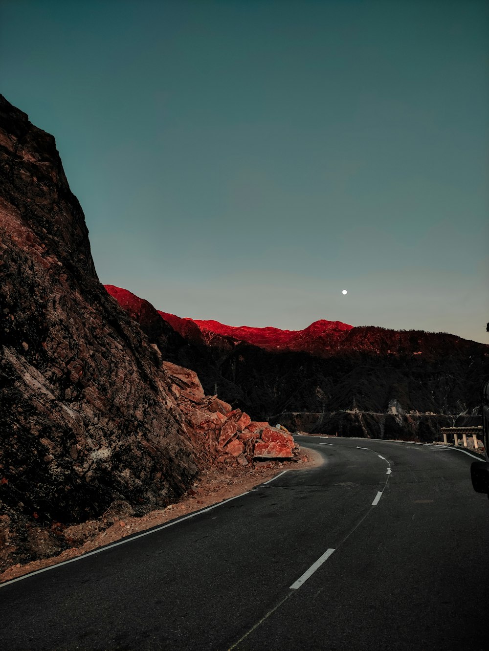 gray asphalt road between brown mountains during daytime