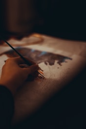 person drawing on white paper