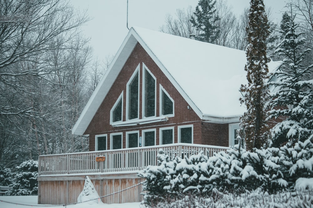 brown and white wooden house near trees during daytime