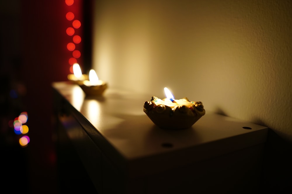 lighted candles on brown wooden table