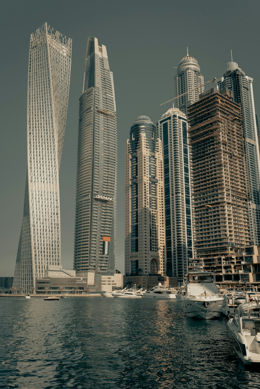 white and brown high rise buildings near body of water during daytime