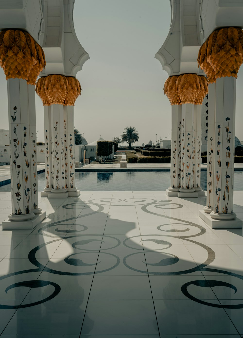 white concrete pillar near swimming pool during daytime