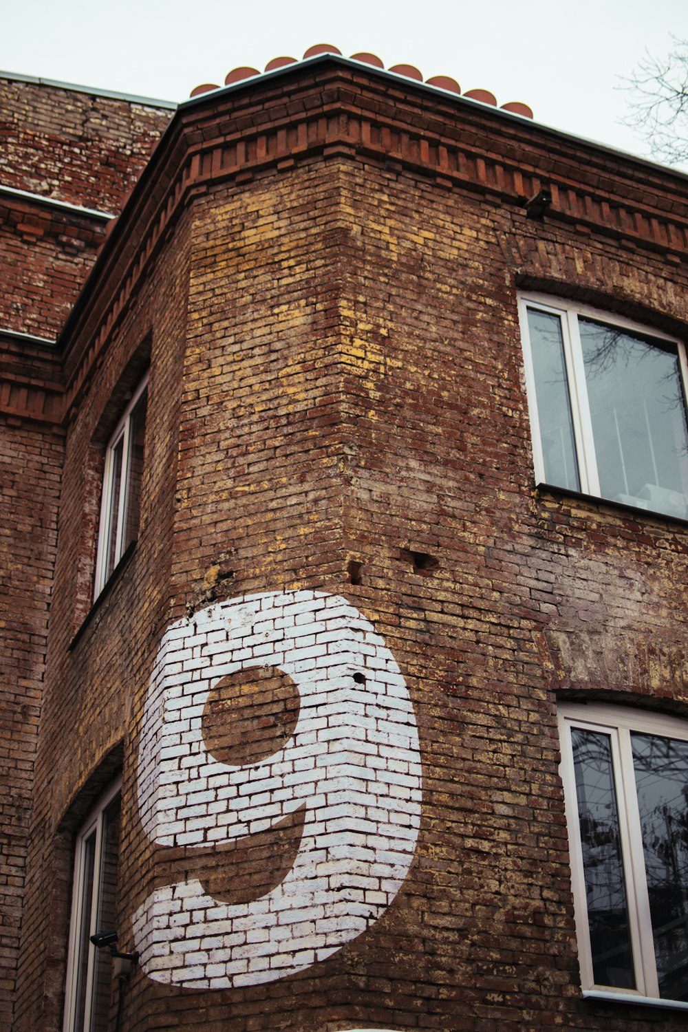 brown brick building with white wooden window