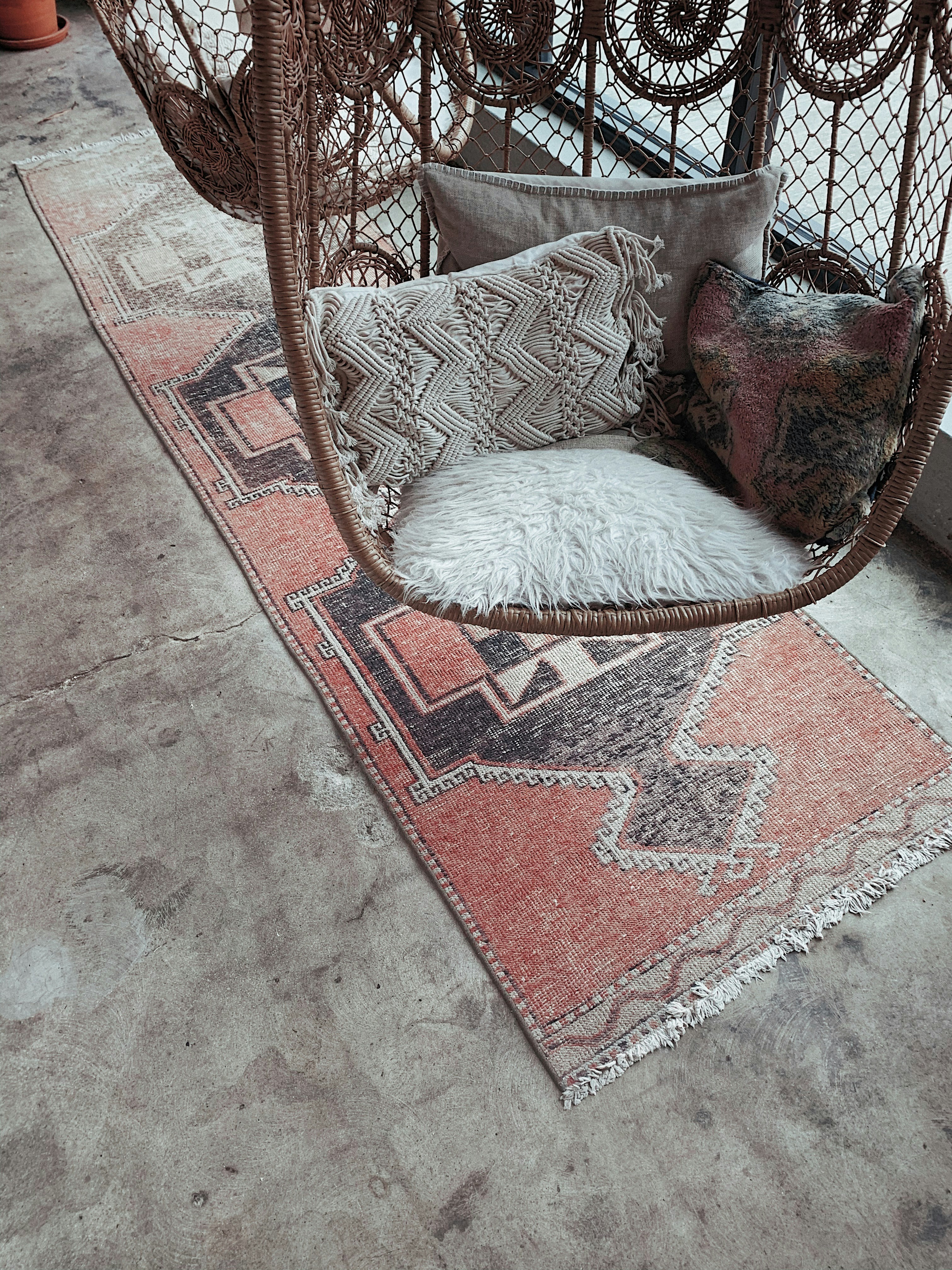 white fur throw pillow on brown and white armchair