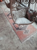 white fur throw pillow on brown and white armchair