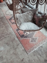 white fur throw pillow on brown and white armchair