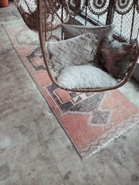 white fur throw pillow on brown and white armchair