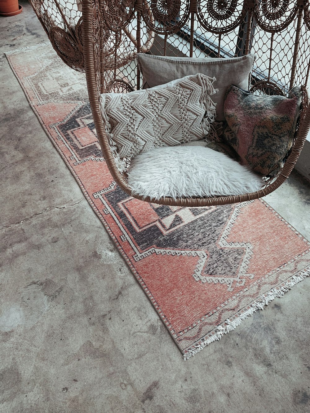 white fur throw pillow on brown and white armchair